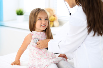 Doctor examining a little girl by stethoscope