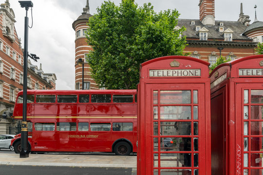 LONDON, ENGLAND - JUNE 16 2016: Phone booth and Red Bus on Westminster, London, England, Great Britain
