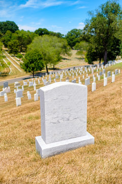 Tombstones on a grassy hill at Arlington National Cemetery