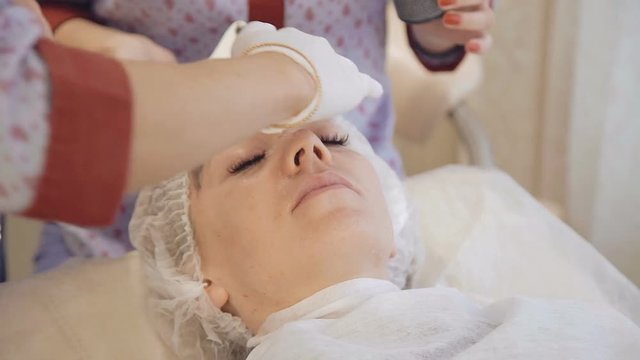 Applying marine mug mask on female face