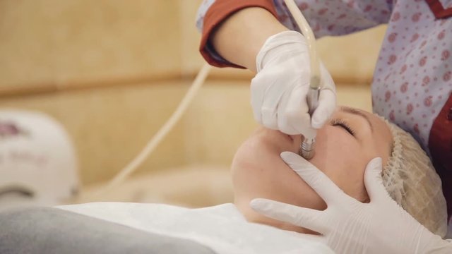 Beautiful woman getting microdermabrasion at beauty clinic