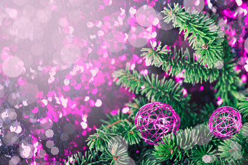 Purple Christmas bauble with pine on a sparkling background