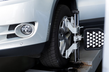 Car wheel adjusted with automobile alignment