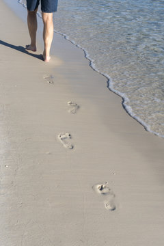 footprints in the sand on the beach