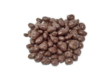 A pile of chocolate covered raisins seem from above on a white background.  Horizontal