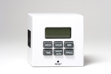 White plug-in timer for electrical items. white background. Mainly used for turning lamps and...