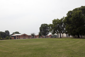 Newly mowed field with elementary school in background. Horizontal.