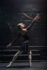 Skilled dancer performing on the dark background