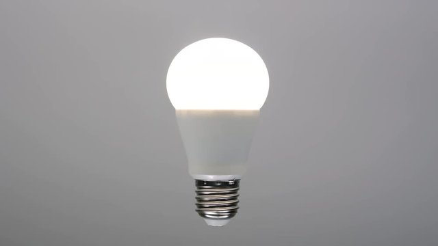 Led bulb turning on, energy saving lamp with e27 socket