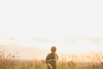 Fototapeta na wymiar standing on a mountain, enjoying the sunset