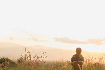 standing on a mountain, enjoying the sunset