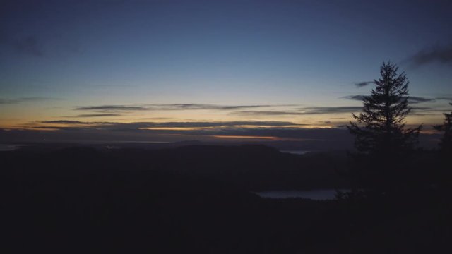 Clouds float by at twilight, overlooking the San Juan Islands and Puget Sound; Orcas Island, Washington State, United States of America