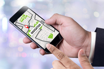 person holding a smartphone on blurred cityscape background