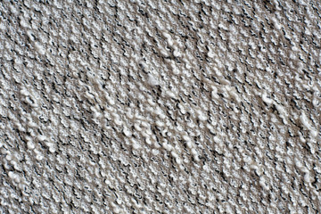 Heather grey knitted fabric made of synthetic yarn. Diagonal direction stitch. Textured background.