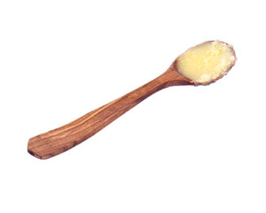 Clarified butter ghee in wooden spoon isolated on white background