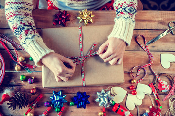 Hands wrapping Christmas gifts