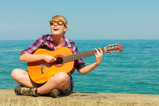 Young woman with guitar outdoor