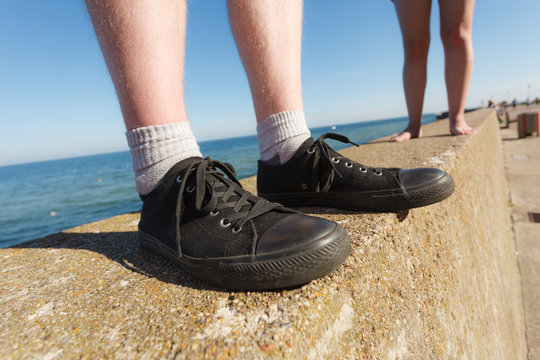 Male feet wearing sneakers outdoor