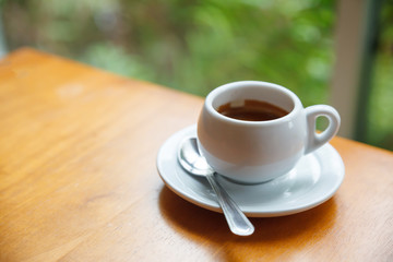 Cup of coffee on table in cafe.