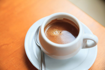 Cup of coffee on table in cafe.