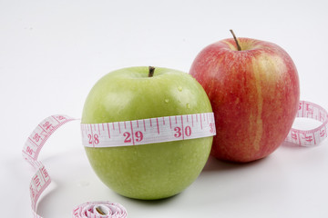 apple and measuring tape on white. Healthy concept