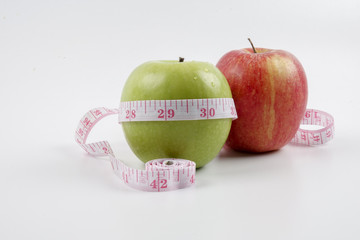 apple and measuring tape on white. Healthy concept