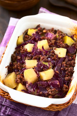 Baked red cabbage, apple, mincemeat and potato casserole in dish, photographed with natural light (Selective Focus, Focus one third into the dish)
