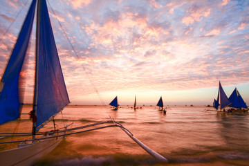 Boat against a scenic sunset in Boracay island, Philippines