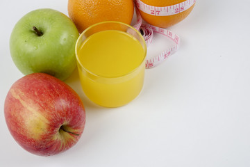 orange and measuring tape on white. Healthy lifestyle concept
