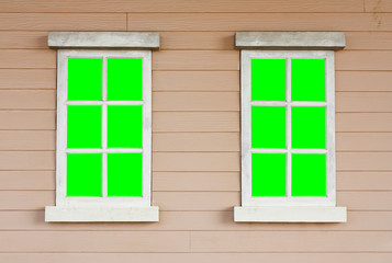 dual or two old wood white window with green screen on the wall