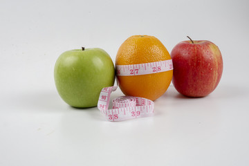 apple ,orange and measuring tape. Lifestyle concept.