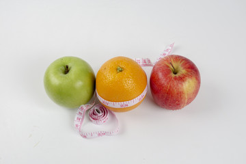 apple ,orange and measuring tape. Lifestyle concept.