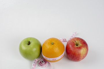 apple ,orange and measuring tape. Lifestyle concept.