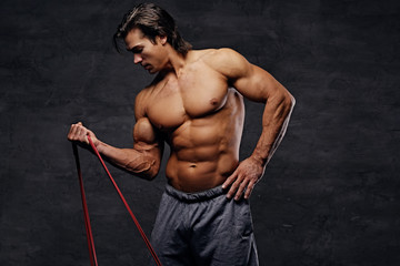 Fototapeta na wymiar A man doing biceps workouts with fitness trx straps.
