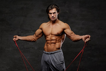 A man exercising with trx straps.