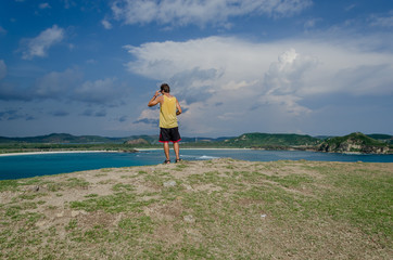 Traveller watching at the coast, Lombok, Indonesia