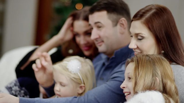 family taking photo with selfie stick