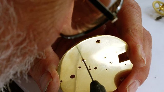 Horologist repairing a pocket watch
