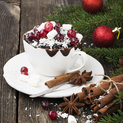 Mug cupcake New Year Christmas with marshmallow and juicy cranberries on a wooden background  toys  pine branches. Holiday breakfast