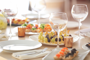 Plate with tasty canapes on table served for holiday buffet