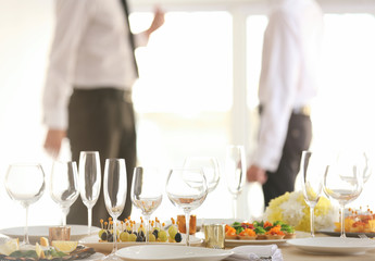 Close up view of table setting for holiday buffet, on blurred background