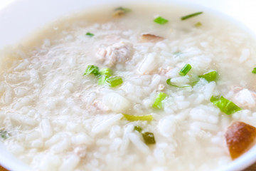 Soft-boiled rice with pork, Thai food style.