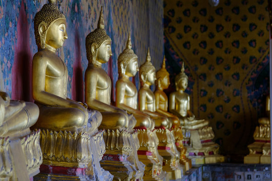  Row of Buddha gold  and thai art architecture in Wat Arun buddhist temple in Bangkok, Thailand.Photo taken on: 21 November , 2016