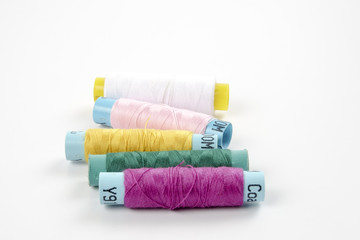Sewing colored threads isolated on white background