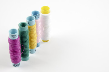 Sewing colored threads isolated on white background