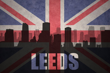 abstract silhouette of the city with text Leeds at the vintage british flag