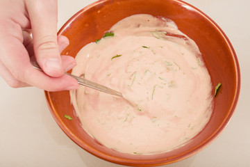 preparing sauce with the green cutted parsley