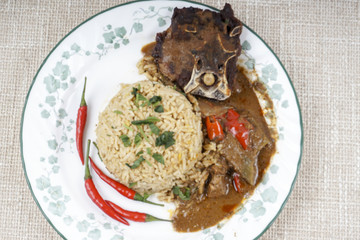 Mutton Byriani - Lamb and rice cooked with spices. Served with raita. Traditional South Asian Cuisine.