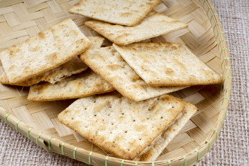 the cream cracker biscuit on the wooden background.