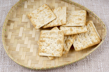 the cream cracker biscuit on the wooden background.